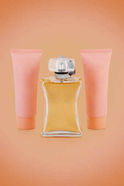 カラフルな背景にシャワージェルとボディローションモックアップ付き高級香水瓶のセット - 写真・画像