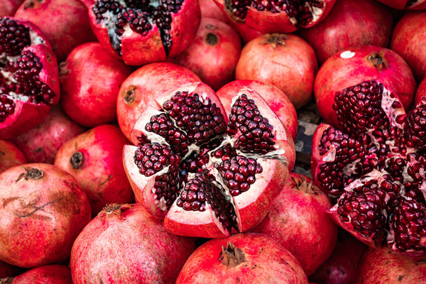 Red pomegranate fruit at street market. Group of pomegranates - Fotó, kép