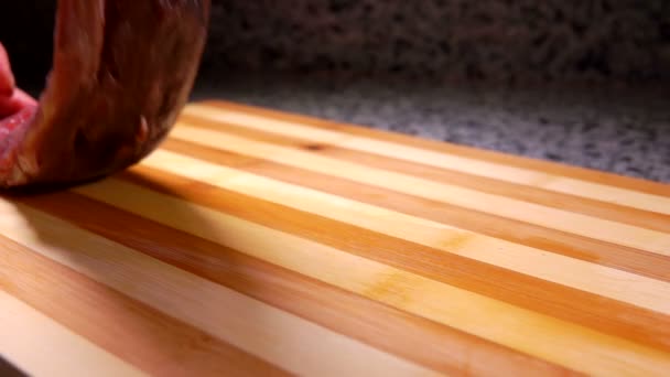 Salted tuna fish fillet fall onto a cutting board - Filmagem, Vídeo