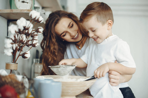 Mother with little son in a kitchen - Φωτογραφία, εικόνα
