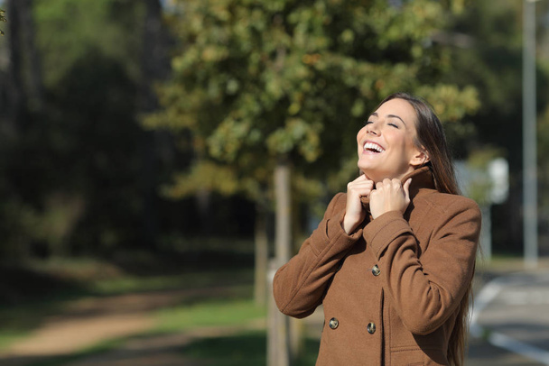 Happy woman warmly clothed in winter breathing fresh air - Фото, зображення