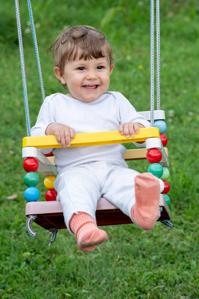 Feliz hermoso niño en swing
 - Foto, Imagen