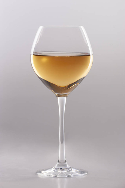 Glass of white wine on a white background and with soft shadow. - Photo, Image