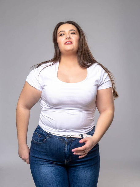 Plus Size Model with long hair posing in studio - Photo, image