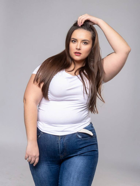 Plus Size Model with long hair posing in studio - Photo, Image