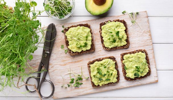 Wholegrain toasts with avocado spread and microgreen - Photo, Image