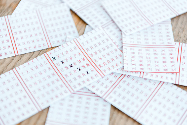 top view of marked lottery tickets on wooden table - Fotoğraf, Görsel