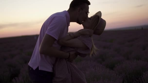 Silhouette kissing at sunset in a field of lavender. - Footage, Video