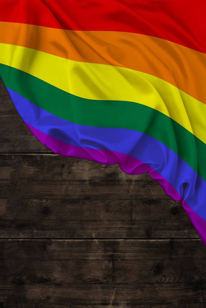 vertical color LGBT rainbow flag, Pride flag, beautiful silk, background old wood, concept of tourism, economy, politics, emigration, independence day, copy space, template - Foto, Imagem