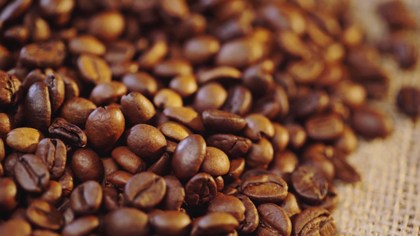 rack focus of brown coffee beans and canvas  - Footage, Video