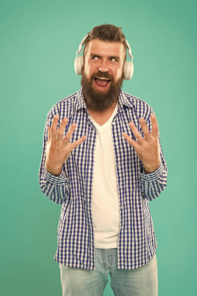 Heavy metal and hard rock. Wireless technology. Hipster with beard listening music. Handsome music lover. Man in headphones. User friendly interface and large library of tunes. Streaming music sites - Fotoğraf, Görsel