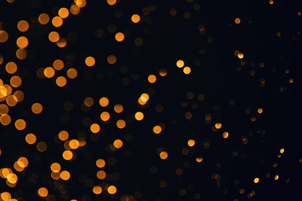 Golden sparkles raster festive background. Bokeh lights with bright shiny effect illustration. Overlapping glowing and twinkling spots decorative backdrop. Abstract glittering circles. - Fotoğraf, Görsel