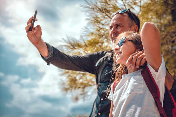 Father and daughter making selfie with smart phone - Photo, image