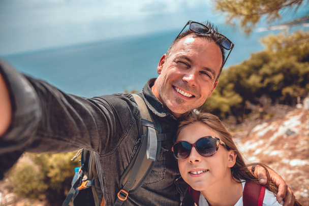 Father and daughter making selfie with smart phone - Photo, image