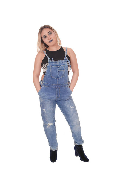 Young woman in working jeans standing in the studio - Foto, Imagem