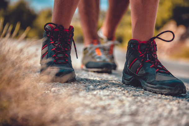 Hikers boots on a mountain road - Φωτογραφία, εικόνα