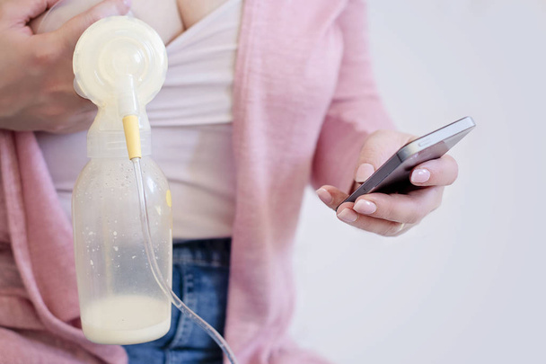 Mother is using single electric breast milk pump - Photo, Image