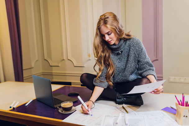 Portrait of smiling female interior designer sitting at office desk. - Fotografie, Obrázek
