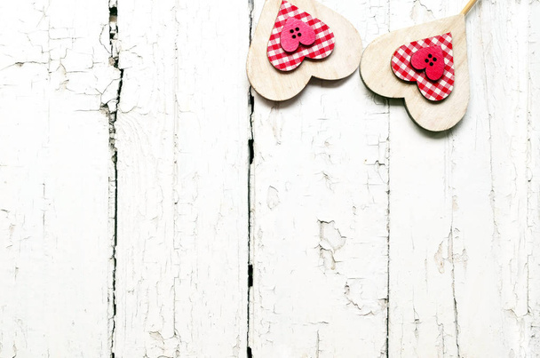 Wooden Background for design to Valentine's Day. Decorative red and white hearts. View from above. Valentines Day concept - 写真・画像