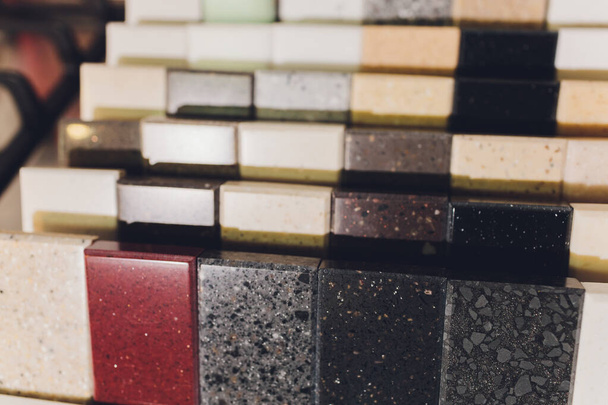 home furnishing store demonstrating variants of stone for kitchen countertop. - 写真・画像