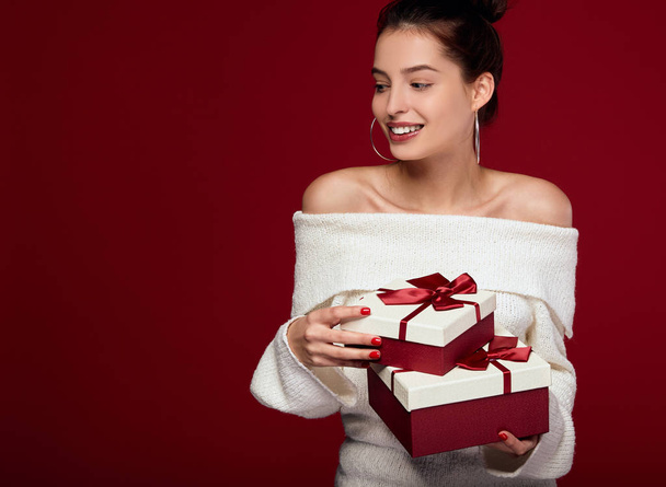 Sexy white young lady holds boxes of gifts. - Zdjęcie, obraz