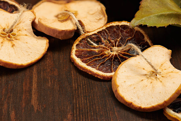 Handmade decoration from dried fruits on a dark wood background with copy space. Top view. - Fotografie, Obrázek