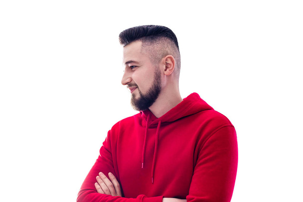 Handsome man in red casual clothes posing with arms crossed on w - Foto, Bild