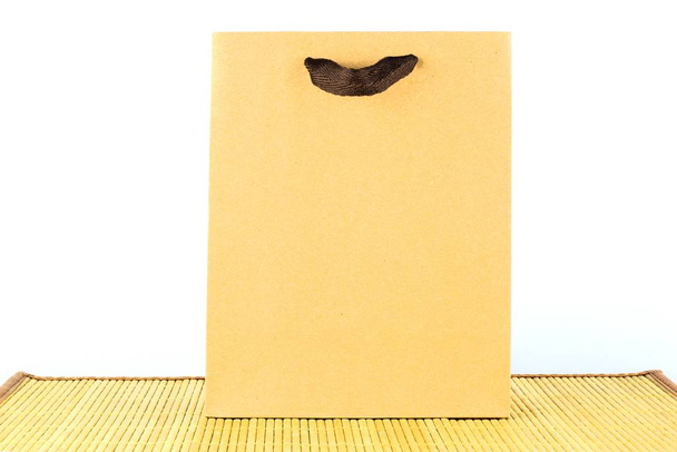 Paper bag for shopping on a light background. Ecologically clean material that does not pollute the environment. - Photo, Image