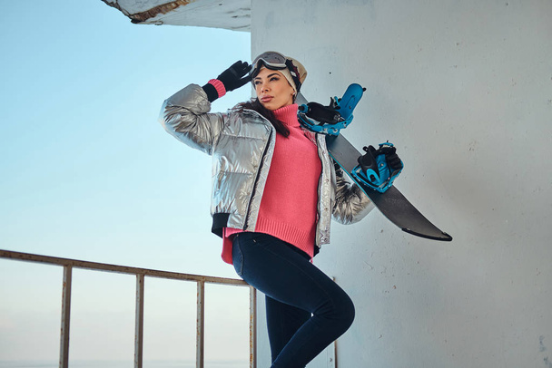 Charming lady with snowboard is posing for photographer - Zdjęcie, obraz