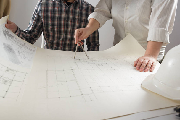 Architects working on blueprint, real estate project. Architect workplace. Construction concept. Engineering tools. - Photo, Image
