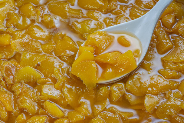 These are peach slices in sugar syrup. - Photo, Image