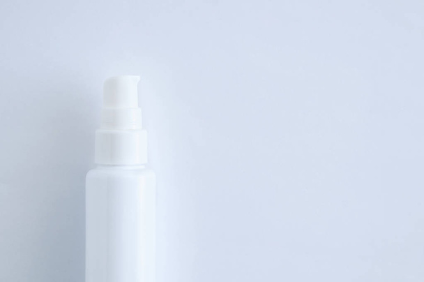White plastic bottle with dispenser closeup. White background. - Fotó, kép