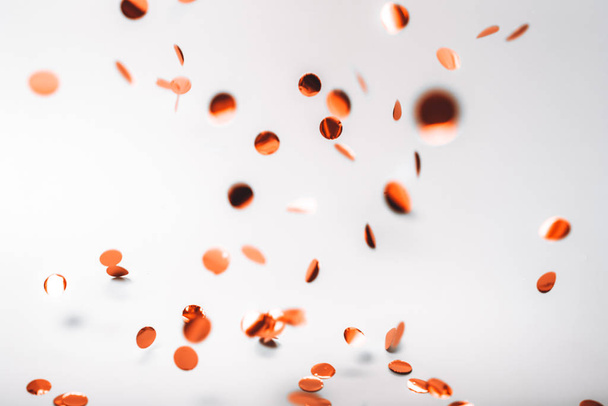 Rose gold falling confetti on white - Foto, afbeelding