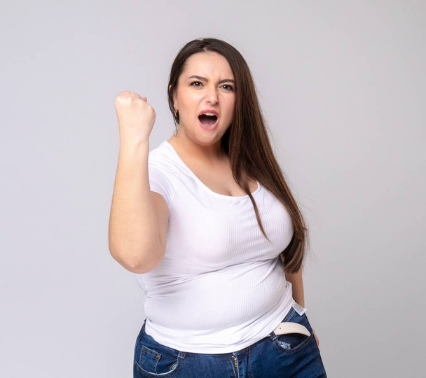 Shocked Plus Size Model with long hair posing in studio. - Photo, Image