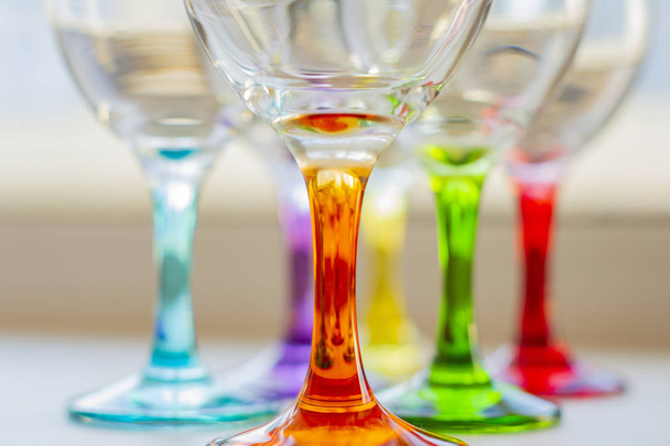 bright multi-colored glasses for wine and drinks. holiday texture. home holidays. home interior. kitchenware - Foto, Imagem