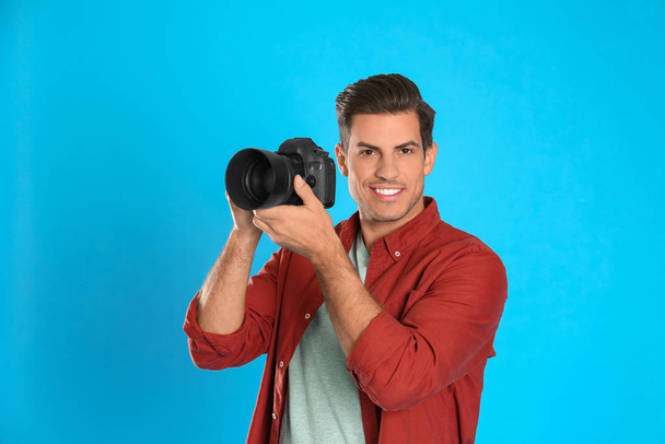 Professional photographer working on light blue background in st - Foto, immagini