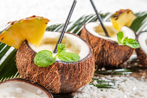 Pinacolada in a coconut on old white table - Foto, Imagem