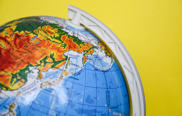 globe sphere on the yellow background, place for text - Photo, Image