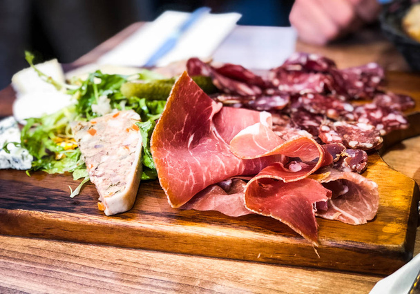 delicious french charcuterie plate with fresh ingredients - Fotó, kép