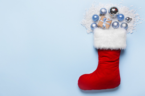 Christmas sock with gift and decor on color background - Photo, Image