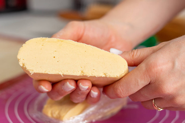 Cut dough on hands in the kitchen - Photo, image