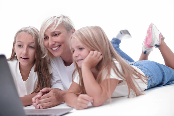 mom and daughters watching their favorite video on a laptop - Photo, Image