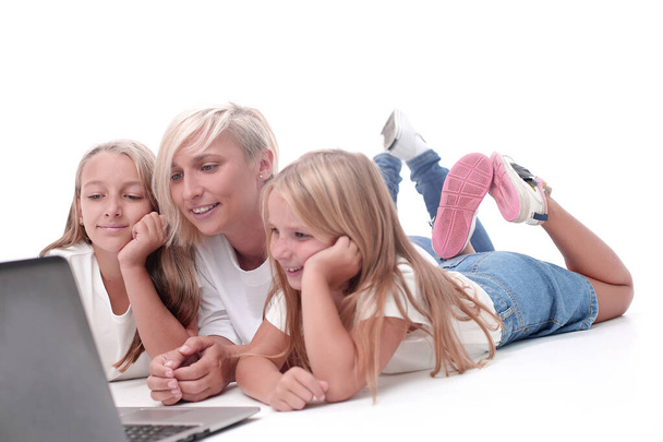 mom and daughters watching their favorite video on a laptop - Foto, imagen