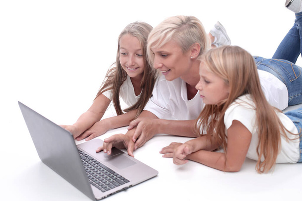 close up. mom and daughters watching a movie on a laptop - Zdjęcie, obraz