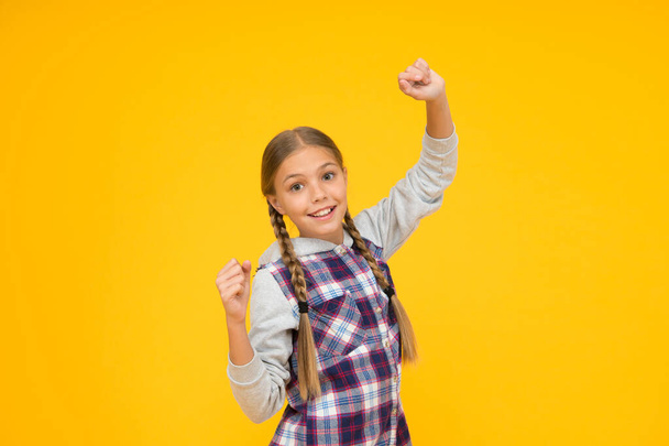 in playful mood. kid fashion. child cute blond hair. childhood happiness. happy childrens day. small girl checkered jacket. autumn time. hipster girl yellow background. happy school girl casual style - Foto, afbeelding
