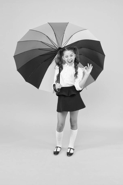 Fancy schoolgirl. Girl with umbrella. Rainy day. Happy childhood. Rainbow style. Kid happy with umbrella. Fall weather forecast. Fashion accessory. Rainy september. Accessory for rainy day. Stay dry - Φωτογραφία, εικόνα