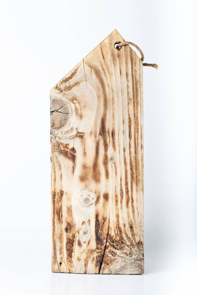 Handmade burned cutting board on a light background. Rough weath - Фото, изображение