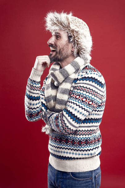 Hipster dreamer. Winter on his mind. Alone with thoughts. Man bearded hipster wear furry hat striped scarf and knitted sweater. Mature hipster with beard mustache dreamy face. Imagine future. What if - Fotografie, Obrázek