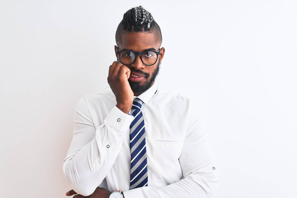 African american businessman with braids wearing tie glasses over isolated white background looking stressed and nervous with hands on mouth biting nails. Anxiety problem. - Foto, Bild