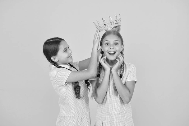 She is the best. Happy schoolgirls and golden crown symbol of success. Success and respect. Little princess. Motivational award for school children. Succeed in education. Celebrating success - Foto, Bild